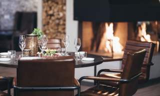 Restaurang med dekket bord och ild i peisen, setesdal