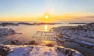 View of Risør town and the sea on a winter day at sunrise