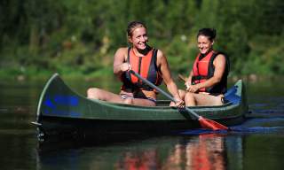 Two girls canoeing on the river