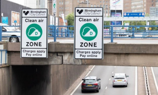 Signs next to road warning clean air zone charges apply