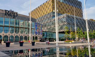 Outside of Birmingham Repertory Theatre; a glazed exterior with large lettering above saying 'the Rep'.