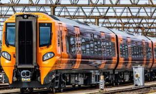 West Midlands Trains Class 196 train in orange and purple livery