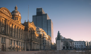 Early morning in Victoria Square, Birmingham, showing council house and statue of Queen Victoria in front of 103 Colmore Row in the distance.