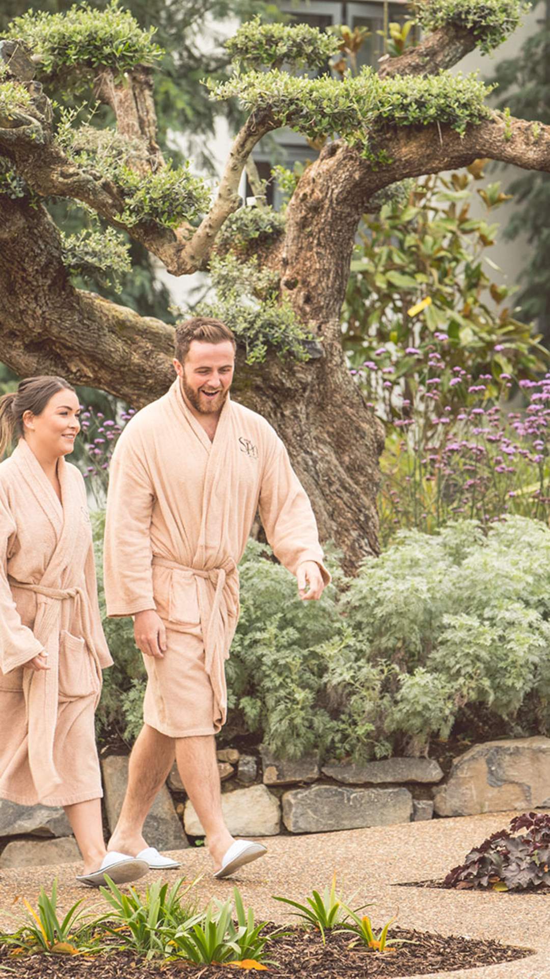 couple walking in the grounds of the thermals spa village at Galgorm Resort & Spa, County Antrim.