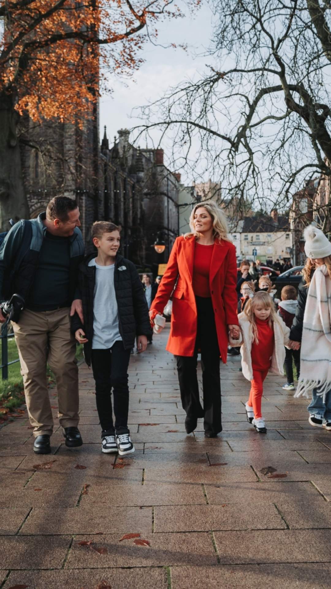 Family strolling through a park in County Armagh on a dull day.