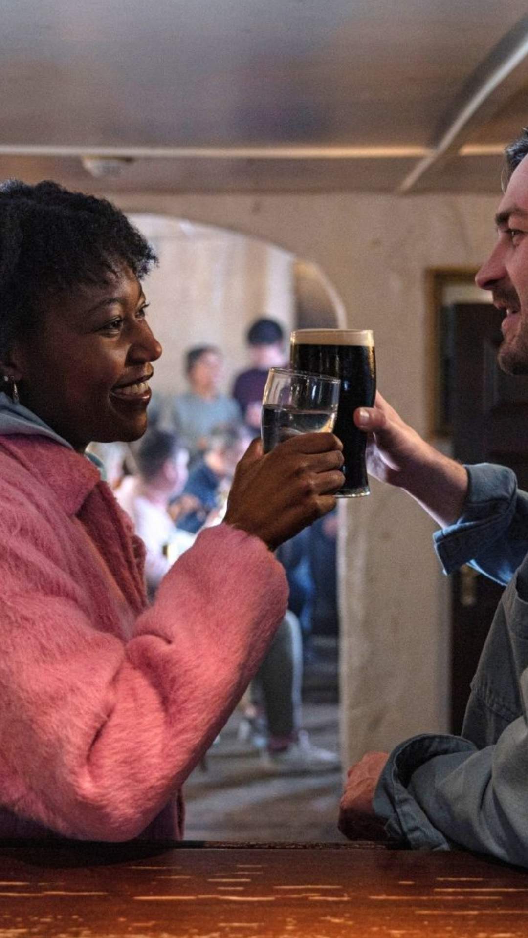 A couple enjoying a pint of Guinness and traditional Irish music sessions at the Crosskeys Inn, Toomebridge, County Antrim.