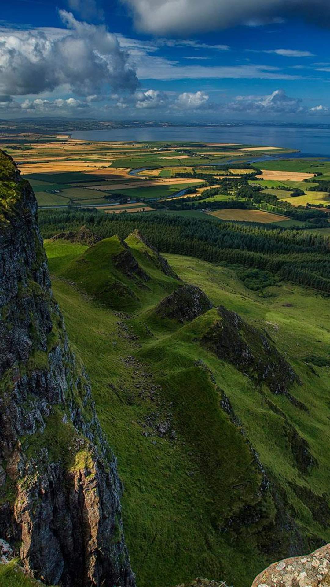Top of Binevenagh over looking green farmland with Donegal in the distance