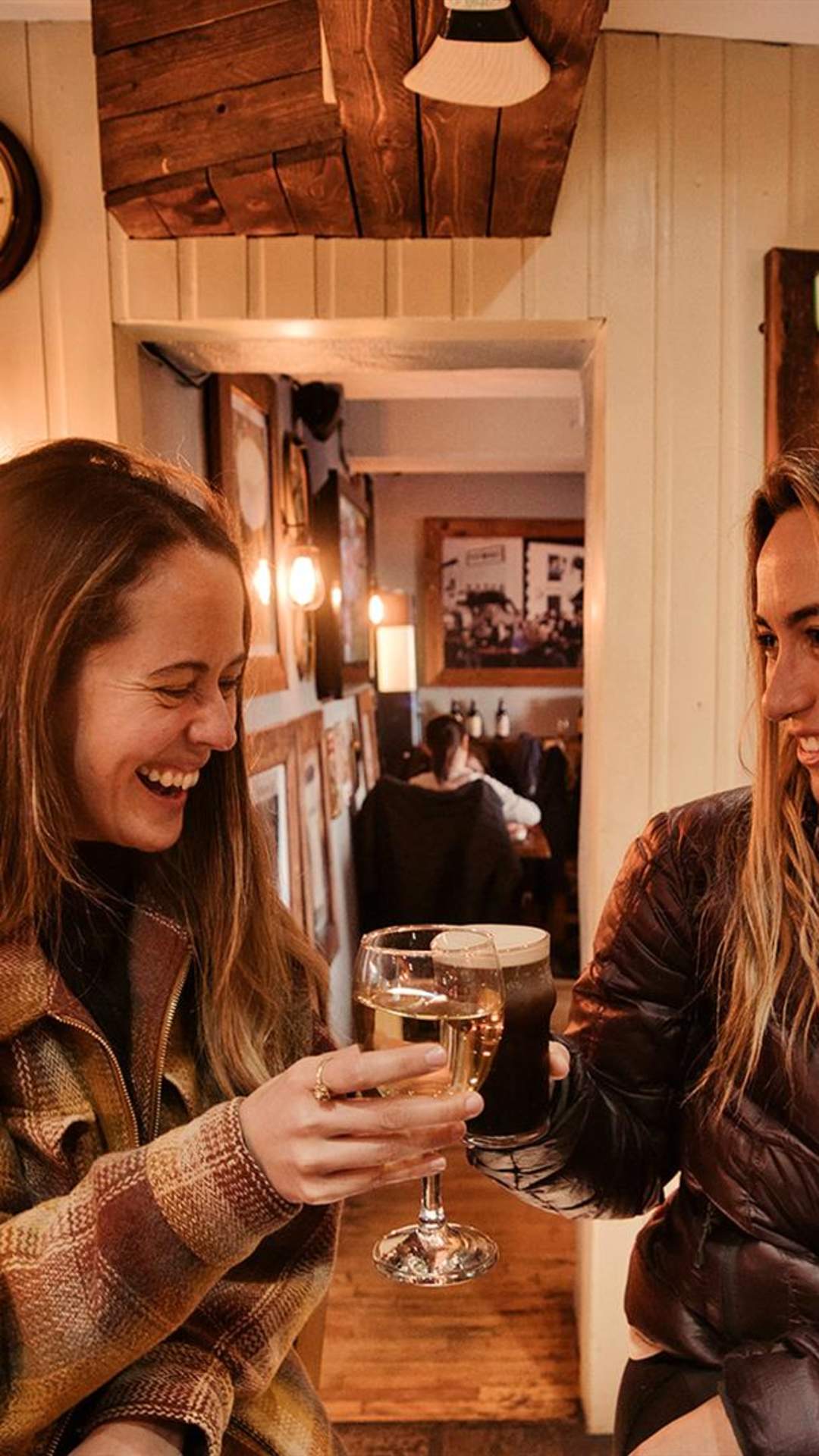 2 girls enjoying a drink in Mary McBride's in Cushendun