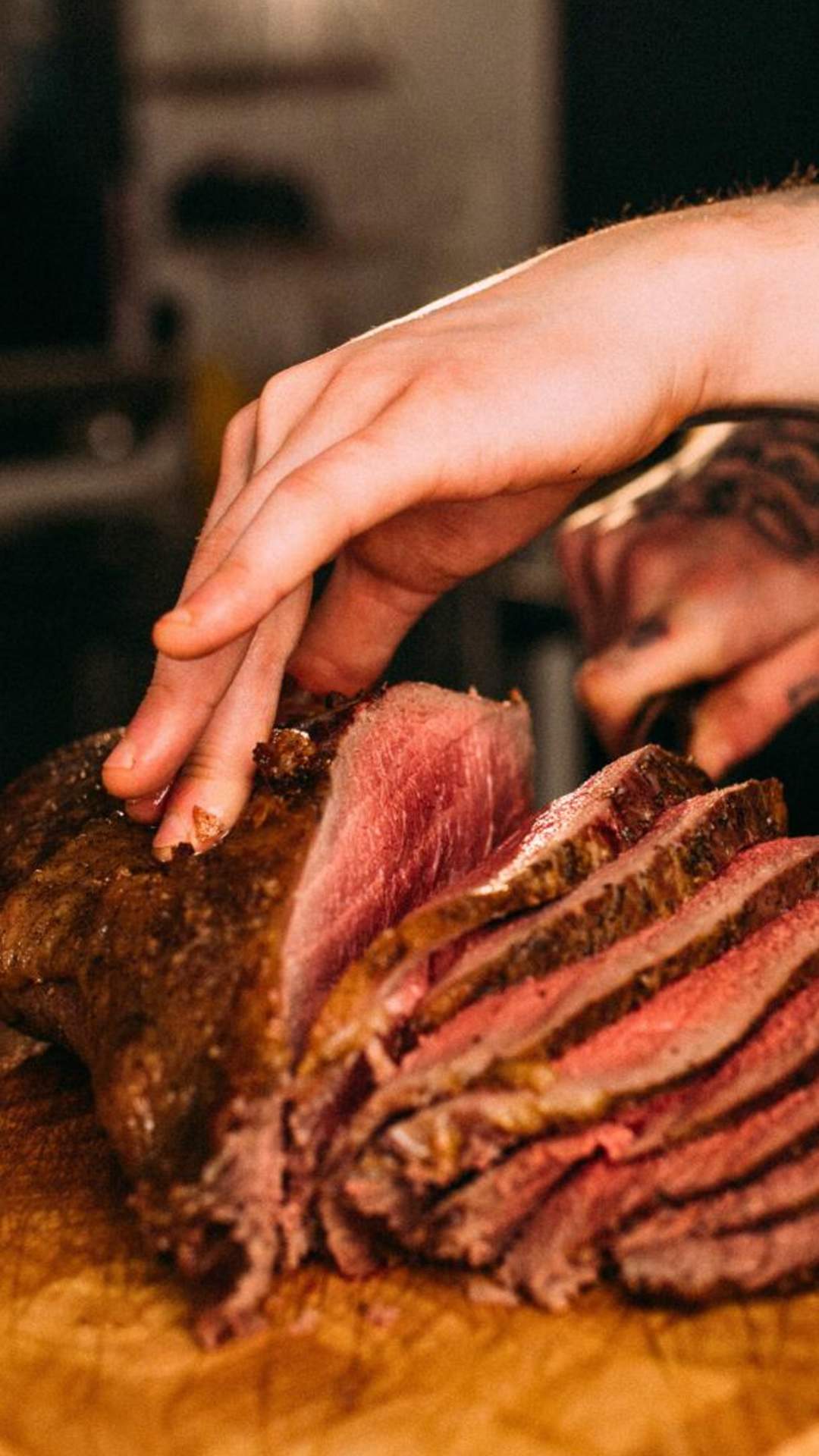 A chef slicing a large piece of beef for Sunday Lunch