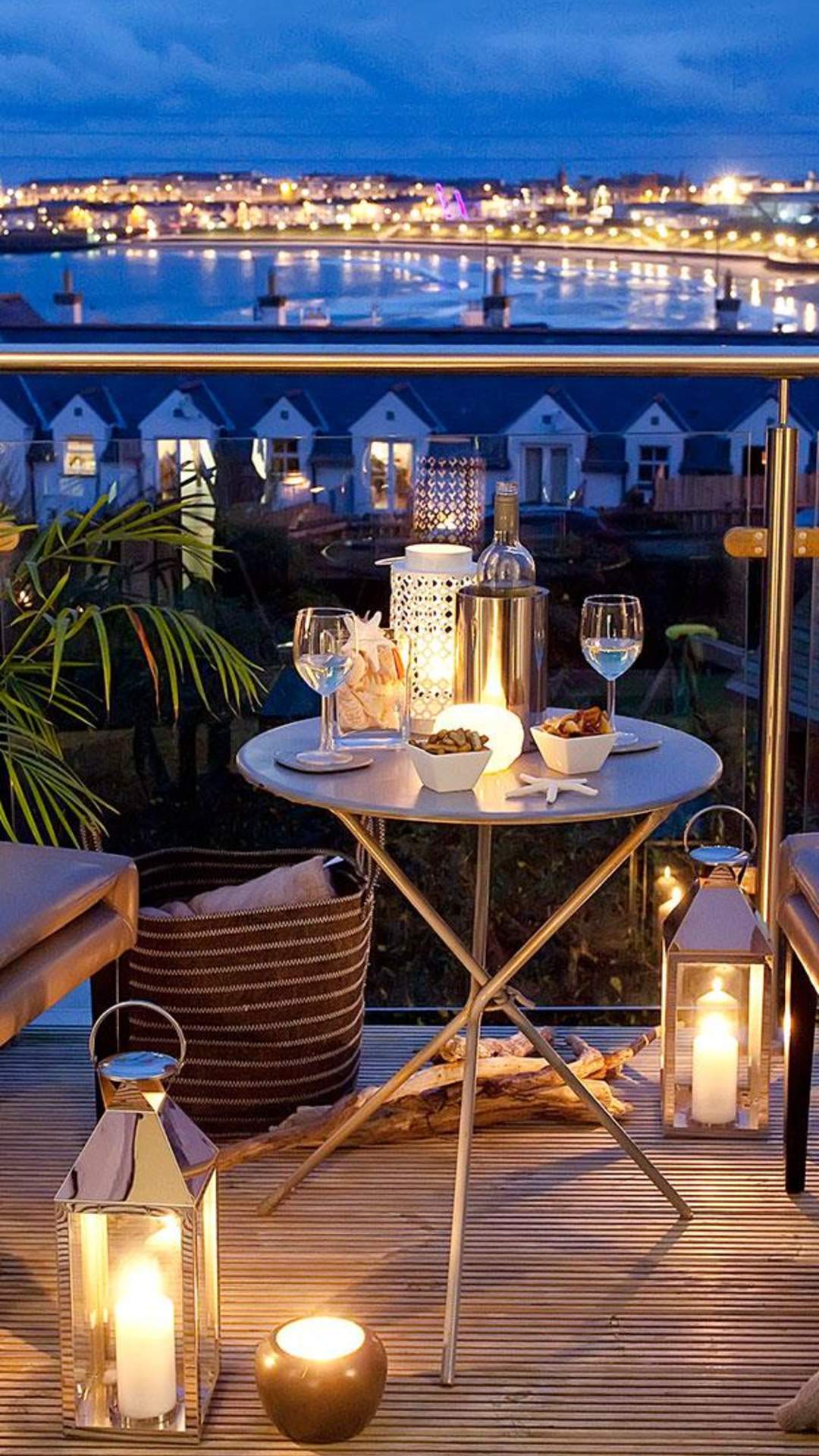 beautiful night time view from the Blackrock House B&B. Candle lit table and two chairs for an evening drink