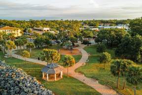 An aerial view of Neptune Park and Pier Village on St. Simons Island, GA.