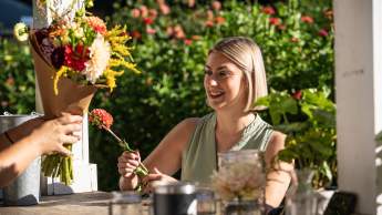 a customer purchasing beautiful flowers at Terra Farms