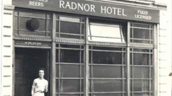 A black and white photograph of a woman standing outside The Radnor Hotel in Bristol - credit University of Bristol