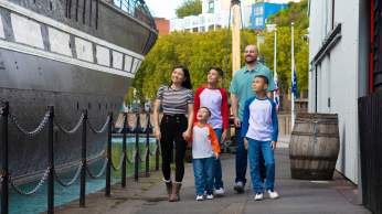 A family exploring the exterior of the SS Great Britain in the Great Western Dockyard, Bristol - credit Brunel's SS Great Britain