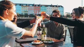 Friends drinking cocktails and wine on the terrace at Harbour House in the Redcliffe area of Bristol - credit Harbour House