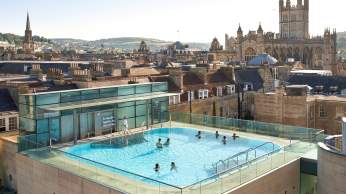 An aerial view of the rooftop pool at the Thermae Bath Spa in central Bath near Bristol, with Bath's skyline in the background
