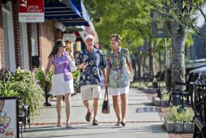 3 people walking down the street