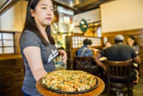 woman holding dish of food