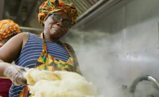 African American woman making food