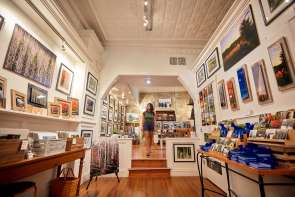 Person walking through an art gallery.