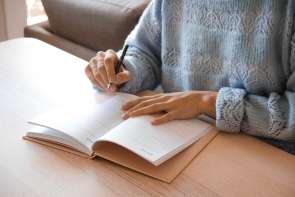 Woman writing in agenda