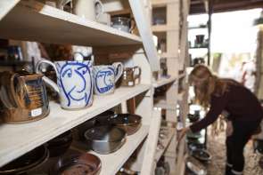 A person shopping for pottery