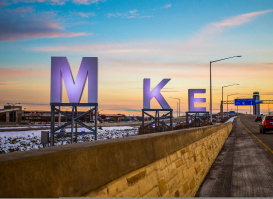 big MKE letters by airport, sunrise