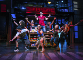 group of performers on stage, posing