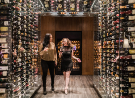 two women with wine walking in "wine tunnel"