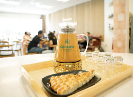 Coffee tray and pastry in bright room