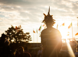 individual speaking into microphone with sunset behind