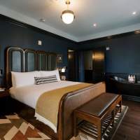 Hotel room with bed, rug, nightstand