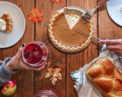 Pumpkin pie on a Thanksgiving inspired wood table