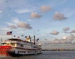 Please arrive by 5:30pm for early boarding. Upon arrival, you'll be greeted by a ship staff member to take you onboard. Start the night off with a complimentary Champagne cocktail and get front row access to the Dukes of Dixieland before dining. After enjoying the tunes and maybe a little dancing, settle into your reserved table in the dining room for a dinner buffet featuring local favorites. If you are looking for a little more, upgrade your cruise to include an open call brand bar. After dinner, take a tour of the vessel led by the first mate. Don’t miss this opportunity to cruise through New Orleans in style on an exclusive VIP cruise that can’t be booked anywhere else! Please note the Steamboat NATCHEZ is taking some time off, but her sister vessel, the Riverboat CITY of NEW ORLEANS will be taking her place. You’ll get the same authentic riverboat experience and all the beautiful New Orleans sites, while also exploring the newly renovated riverboat.