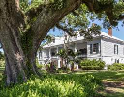 St. Joseph Plantation is one of the few fully intact sugar plantations in the River Parishes. In addition to the Manor Home, this historic site features many outbuildings for guests to explore. These include original homes of enslaved people, a detached kitchen, blacksmith’s shop, school house, and chicken coop. Several buildings have been moved to their present day location from other parts of the property, but most remain where they were built. The initial structure of the St. Joseph House was built by the 1830’s and expanded by the 1850’s. The expansion was funded by dowry money that was given to Josephine Aime Ferry by her father, Francois Gabriel “Valcour” Aime. In 1877, Joseph Waguespack purchased the plantation and named it after his patron saint. Later, one of his grandsons purchased Felicity Plantation. In 1901, his grandchildren formed the St. Joseph Planting and Manufacturing Co., LTD. and merged the two plantations.