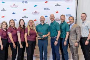 Sports Salt Lake team holding award