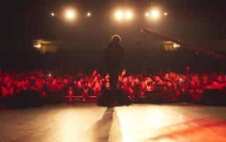 Performer on stage in front of cheering audience