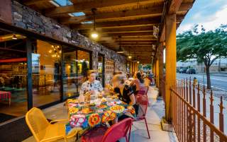 Image of people eating on the patio of Red Iguana 2