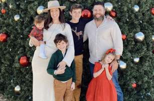 family in front of Christmas tree