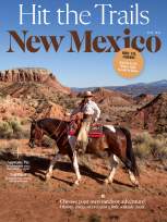 Person on horseback rides through red‑rock desert scenery on the cover of a magazine titled ‘Hit the Trails New Mexico.’