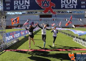 three girls crossing the finish line at War Eagle Run Fest