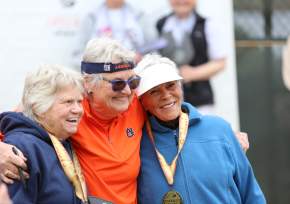 three women at posing for photo at pickleball medal ceremony