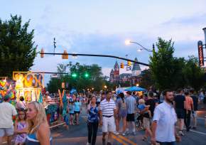 crowd shot of summernight downtown art walk with Samford Hall in background