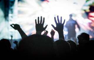 Salt Lake City Concert-goer in the crowd raising their hands