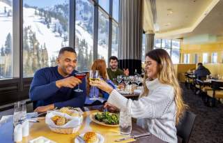 Couple toasting over lunch at The Aerie