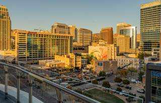 A view of downtown Salt Lake from the 6th floor of the Hyatt Regency. Buildings, one with a mural, bathed in golden light