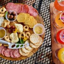 a charcueterie board and mimosa flight board on a table