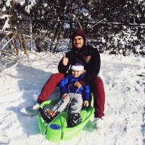 Father and son sledding in Syracuse