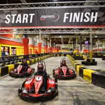 Red Go-Karts racing on an indoor track at destiny usa