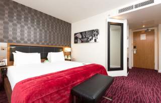 Hotel bedroom with red bedspread